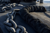 Anchor chain protected with a woven chain guard sock on a boat deck