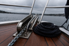 Boat bow roller and neatly stowed anchor chain with a coil of rope