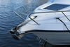 Savwinch Slider Anchor mounted on a bowsprit, close-up of the stainless steel fluke and shank against marina water
