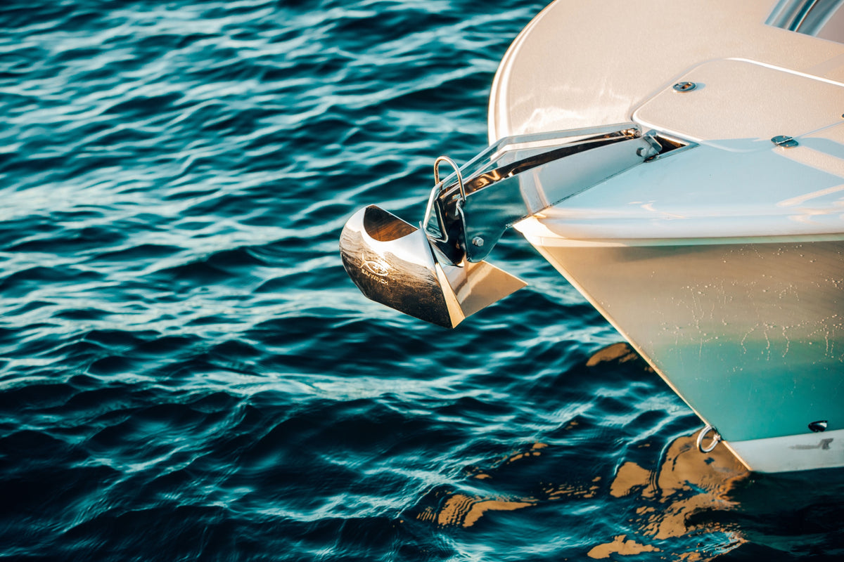 Stainless steel Slider anchor stowed on the bow of a boat over deep blue water
