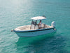Centre console boat with a stainless anchor on the bow, on clear turquoise water in the Whitsundays